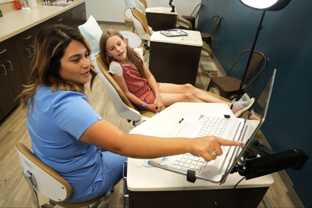 Hemphill team member discussing Prosper orthodontic treatment options with a patient.